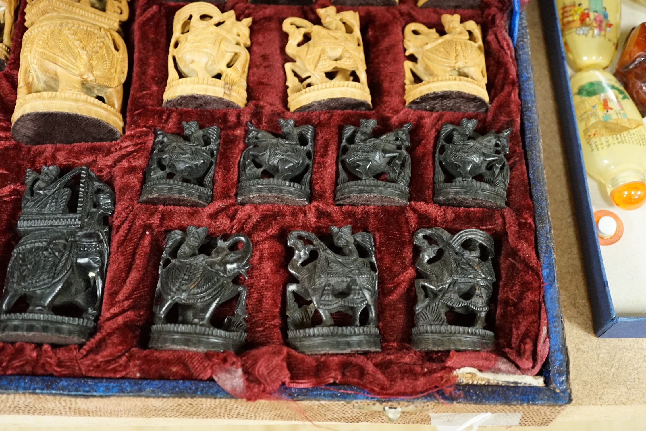 A cased Indian sandalwood and ebony figural chess set, case 50.5cm wide
